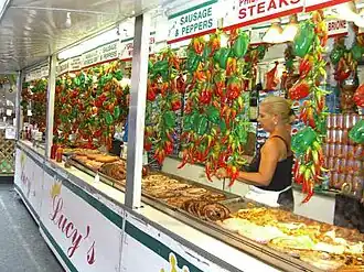 Vendors selling cheesesteak sandwiches, sausages and other foods line the streets