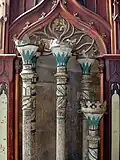 Torchbearers next to the altarpiece in the chancel.