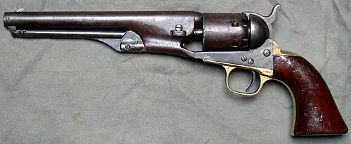 A revolver photographed on a gray background