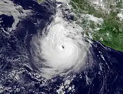 A photograph of a powerful hurricane off the Pacific coast of Mexico. There is slightly less convection and cloud cover in the top-right quadrant of the storm compared to the other three quadrants.