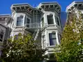Projecting cornice of a painted wooden Italianate residence