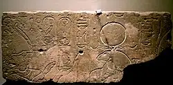 Psamtik II offers a sacrifice to the god Khnum wearing a solar disk (right).