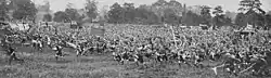 Magazine clipping with photo. The caption reads "The Boy Scouts Charge Past Prince Arthur of Connaught Shouting their Patrol Calls - At Perry Hall Park, near Birmingham. Prince Arthur of Connaught attended a rally of 30,000 Boy Scouts from all parts of the Empire and from foreign countries. The above rather alarming performance was the "star turn" of the day "