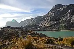 A rocky hill beside a lake.