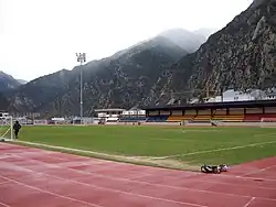 The pitch, covered stands, and all-weather athletics tracks at the national football stadium