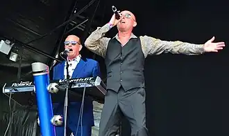 Heaven 17 performing live in 2014Left to right: Martyn Ware (keyboards), Glenn Gregory (vocals)