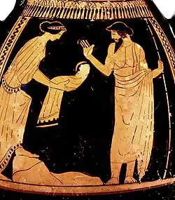 Young woman holds out a hollow horn to an infant's mouth