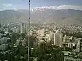 نمایی از برج‌های واقع در منطقه الهیه و در پشت آن نمایی از رشته کوه‌های البرز.