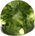 زبرجد با تراش گرد و آخال شیری.