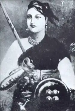 Black-and-white portrait of the Rani of Jhansi holding a sword and riding crop, and wearing jewellery.