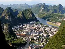 The town of Yangshuo from a nearby karst peak known as the TV tower. The Li River can be seen in the background.