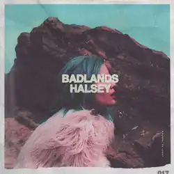هالزی جلوی یک صخرهٔ بزرگ ایستاده و پالتوی خز صورتی به تن دارد و موهایش آبی است. کلمات «BADLANDS – HALSEY» صورت او را پوشانده‌اند.